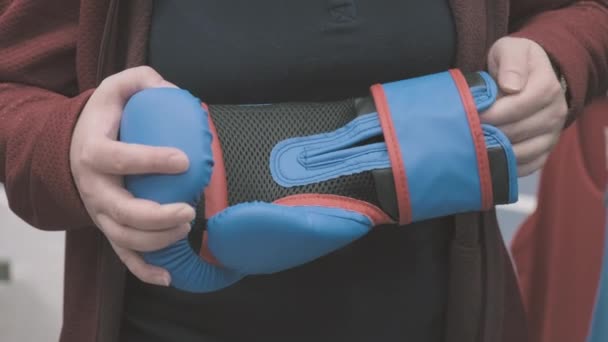 Vrouw in de winkel kiest ervoor om blauwe handschoenen te kopen voor een boksen. Handen van dichtbij. — Stockvideo