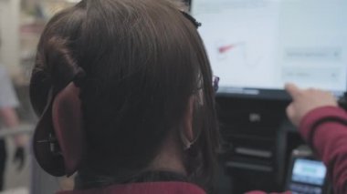 Beyaz bir kadın, alımları terminalden banka kartıyla ödüyor. Yakın çekim.