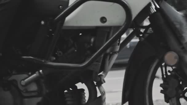 Super slow motion, motorcycle sweeps by against backdrop of an urban landscape — Stock Video