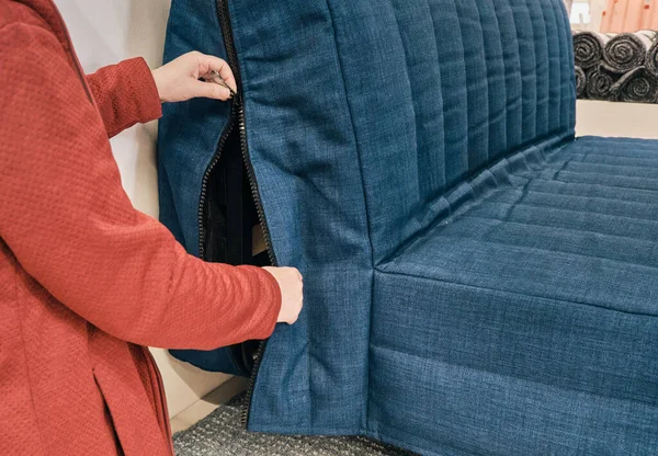 Vit kvinna bär mask mot virus väljer blå soffa i möbelaffär — Stockfoto