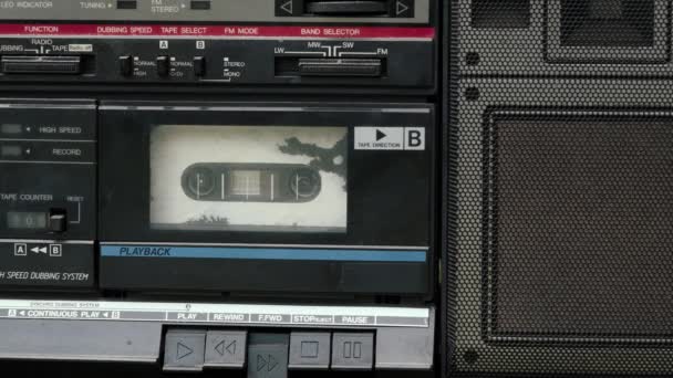 Old, retro tape recorder rewinds a tape cassette. Close up shot — Stock Video