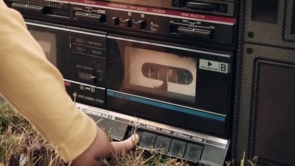 Small child turns on the play button on an old, retro tape recorder — Stock Video