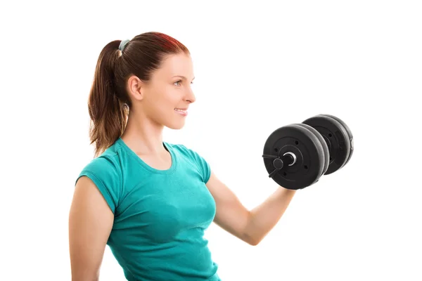 Smiling fit girl lifting a dumbbell — Stock Photo, Image