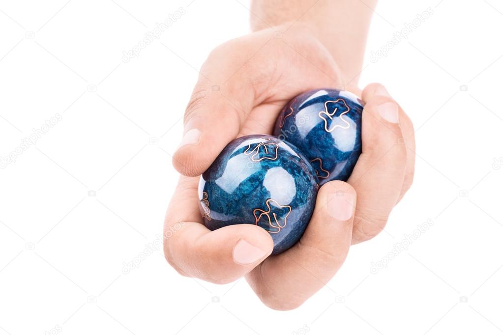 Male hand holding Baoding balls