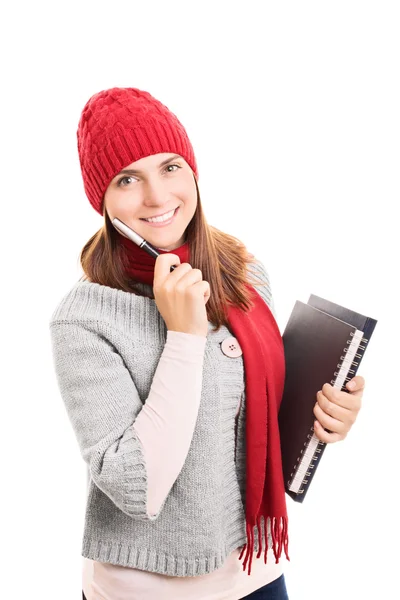 Estudante em roupas de inverno carregando alguns livros — Fotografia de Stock