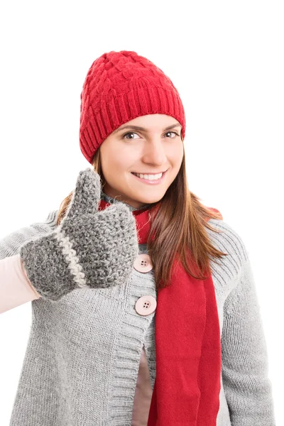 Young girl in winter clothes holding thumbs up — Stock Photo, Image