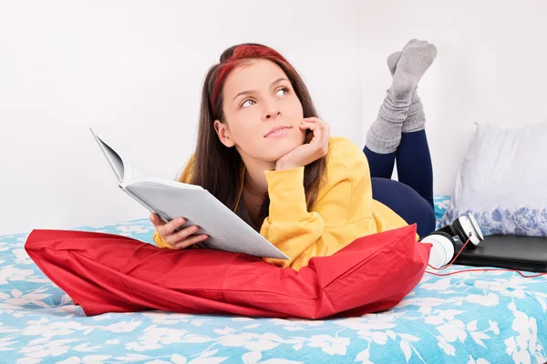 Joven chica sueño-lectura en su cama — Foto de Stock