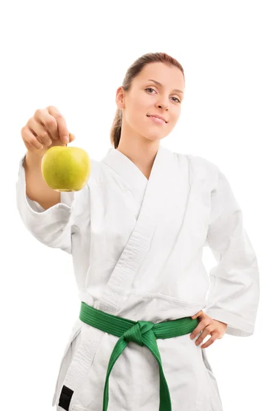 Young girl in kimono holding an apple — Stock Photo, Image