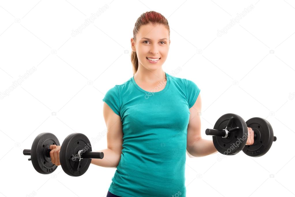 Young girl holding two dumbbells