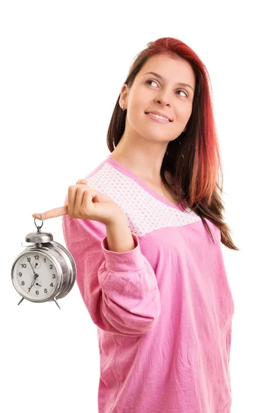 Portrait of a girl in pajamas holding an alarm clock — ストック写真