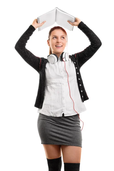 School girl holding an open notebook above her head — Stock Photo, Image