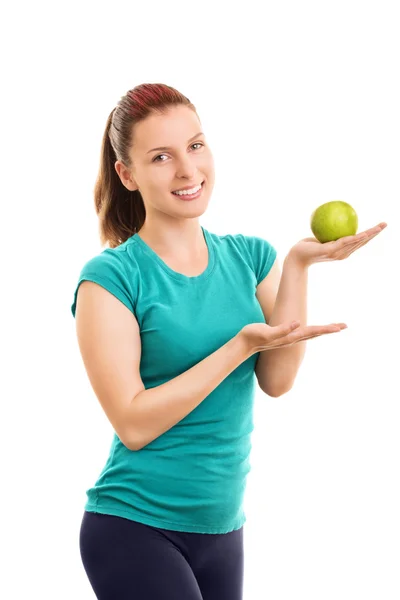 Female athlete holding a green apple — Stock Photo, Image