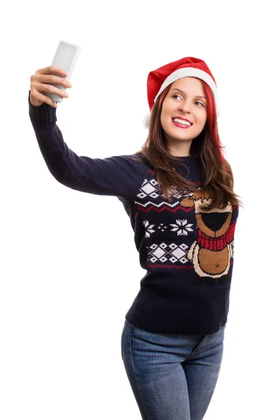 Junges Mädchen mit Weihnachtsmütze macht ein Selfie auf weißem Hintergrund — Stockfoto