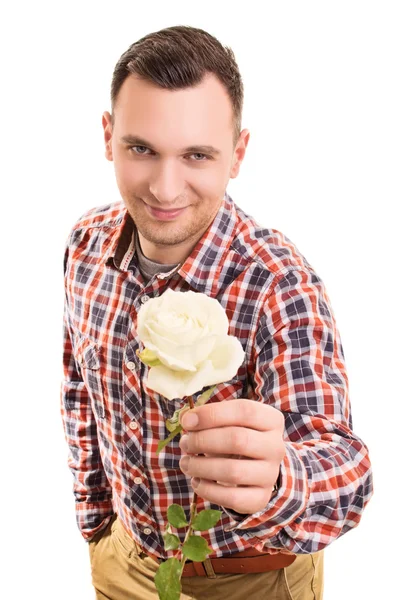 Mladý muž dává květ — Stock fotografie