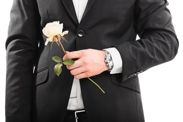 Young man in a suit holding a flower — Stock Photo, Image