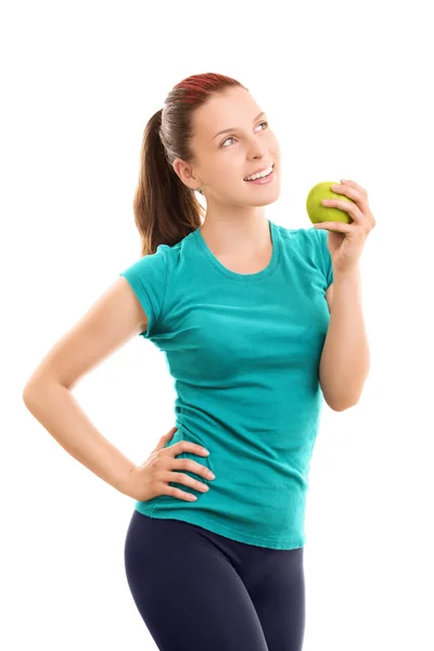 Souriant jeune fille en vêtements de remise en forme tenant une pomme Images De Stock Libres De Droits