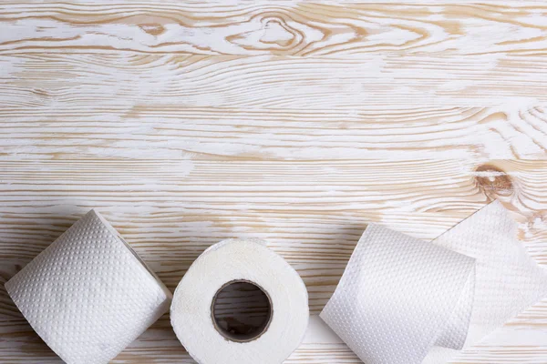 Toilet paper on wooden board — Stock Photo, Image