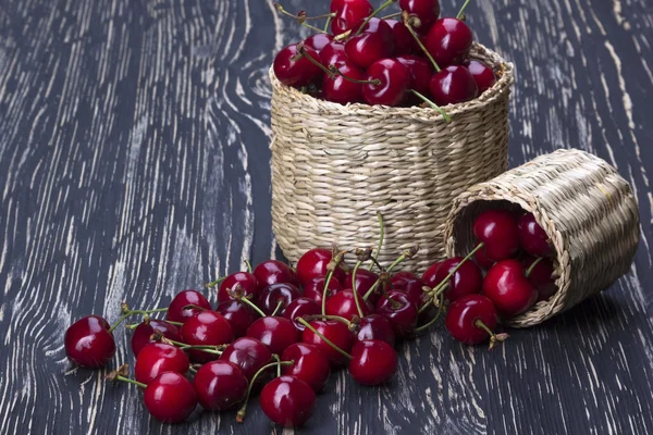 Cherry baskets on wooden background — Stock Photo, Image