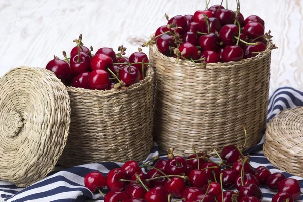 Cherry baskets on wooden background — Stock Photo, Image