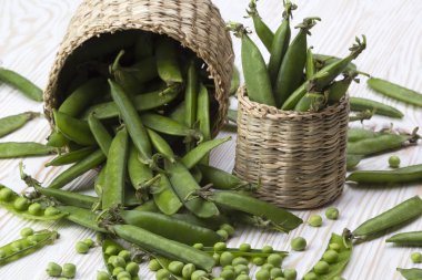 Taze organik yeşil bezelyeler sepette.