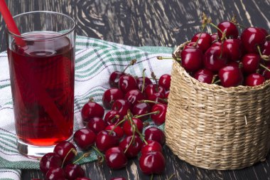 Vişne sepeti ve ahşap zemin üzerine suyu