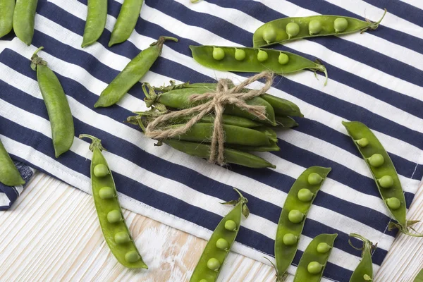 Ahşap masa üzerinde yeşil bezelye.