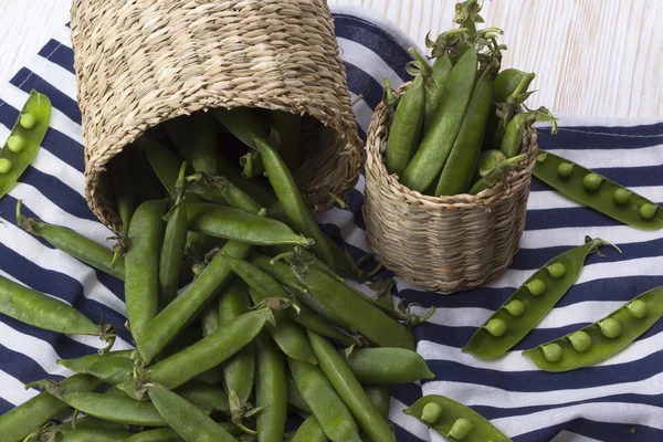 Fresh organic green peas in a basket.