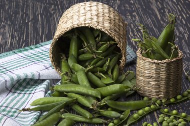 Taze organik yeşil bezelyeler sepette.