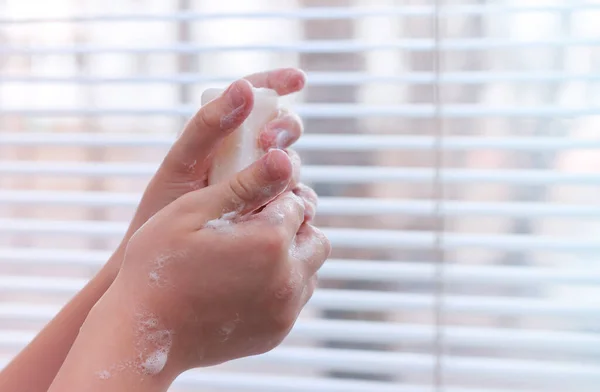 The child washes his hands with soap. Hand washing to prevent viral infection. Hygiene concept. COVID-19