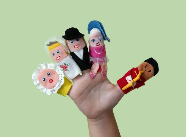 Finger puppet theater. Children\'s hand with figures of puppets. Family concept