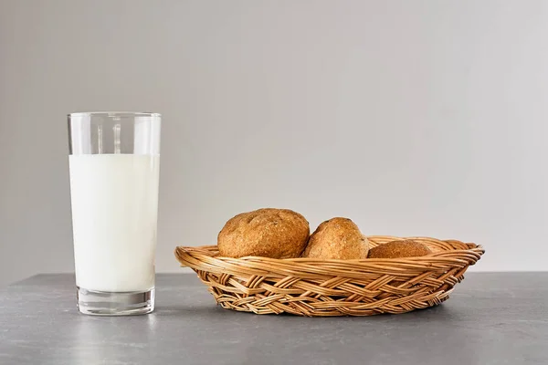 Fresh milk and bread on gray stone table. Kinfolk style. Kefir, milk or Turkish Ayran drink in a glass. Vegan milk. World milk day concept. Space for text