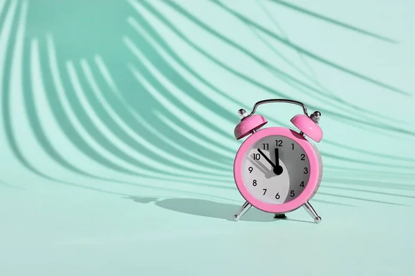 Pink Alarm Clock Light Blue Turquoise Pastel Background Shadow Palm — Stock Photo, Image