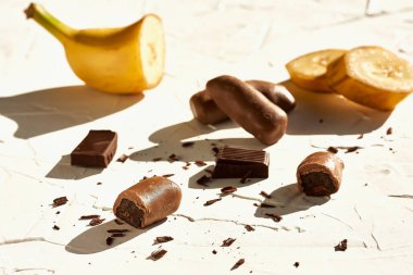 Chocolated coated bananas. Healthy snack, healthy candy. Natural light. Shadow photography.