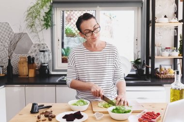 Mutfakta sebze salatası hazırlayan bir kadın. Sağlıklı yemek. Diyet. Sağlıklı yaşam tarzı konsepti. Vejetaryen salatası.