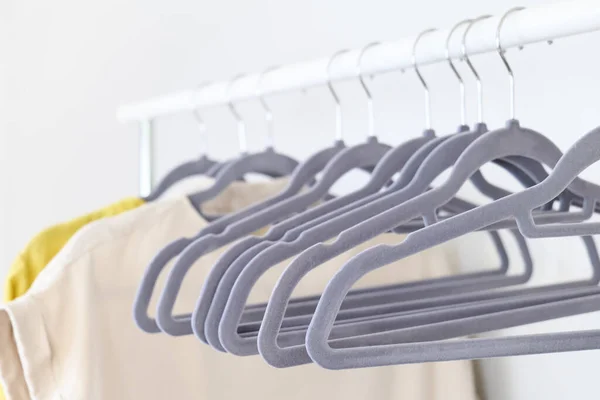 Linen clothes on gray hangers on the clothes rack. Slow Fashion. Conscious consumption. Crisis in the fashion industry, retail. Eco-friendly, Sustainable Sale concept. Zero waste. Black friday.