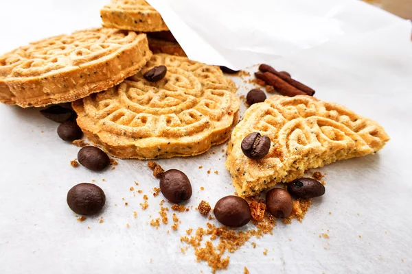 Gluten free chikpea flour chip cookies with coffee beans and cinnamon on recycled baker paper. Cooking sweet homemade cakes gluten free. Selective focus