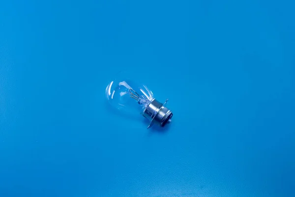 The light bulb of an automotive vehicle on a blue background