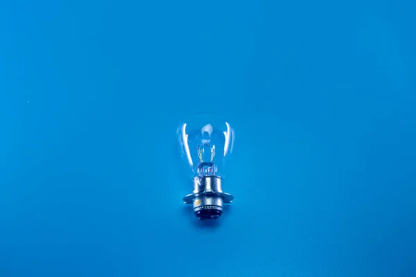 The light bulb of an automotive vehicle on a blue background