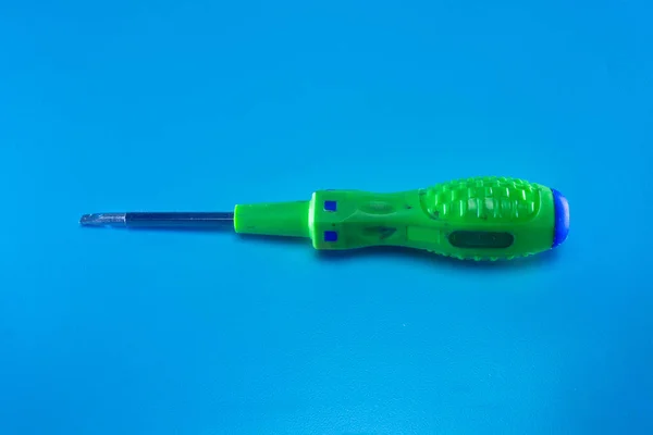 Green Screwdriver Blue Background — Stock Photo, Image