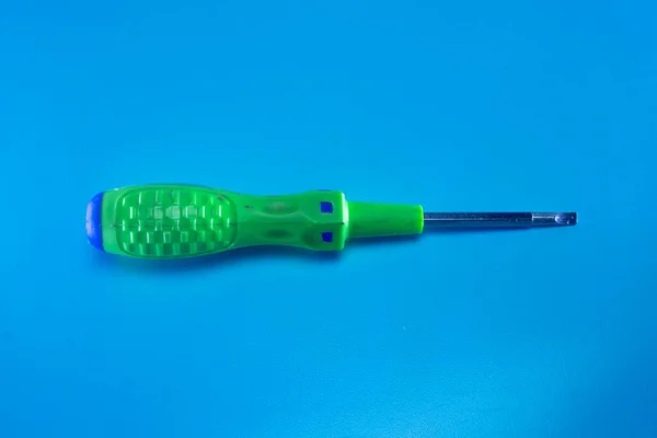 Green Screwdriver Blue Background — Stock Photo, Image