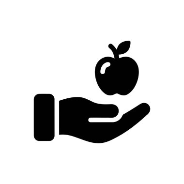 Sağlıklı beslenme ve refahı temsil eden taze bir elma meyvesini nazikçe tutan el.