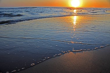 Colorful sunset on the shore of the ocean