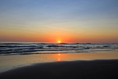 Colorful sunset on the shore of the ocean