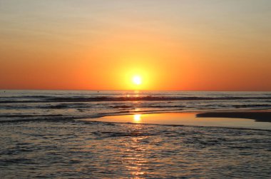 Colorful sunset on the shore of the ocean
