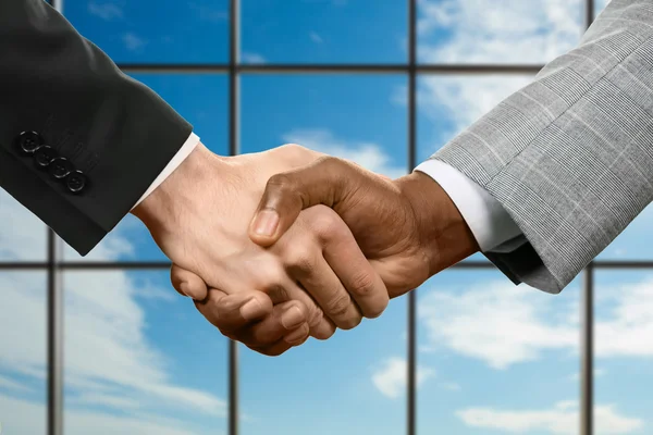 Business handshake on sky background. — Stock Photo, Image