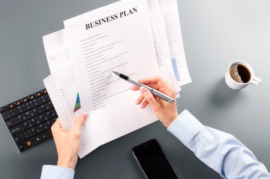 Womans business plan and pen.