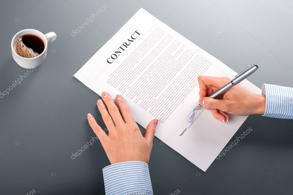 Female manager signing contract.
