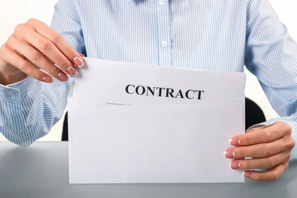 Woman takes contract from envelope. — 스톡 사진