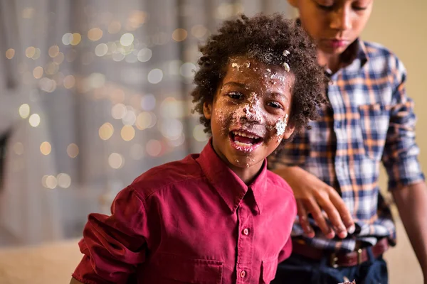 Afro kids cake-smeared face.