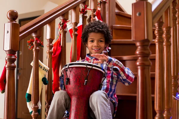Smiling boy playing on drum. — Stock Photo, Image